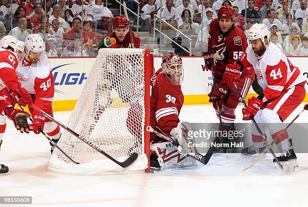 Goaltender Ilya Bryzgalov of the Phoenix Coyotes makes a skate save while teammate Ed Jovanovski and Todd Bertuzzi of the Detroit Red Wings look for...