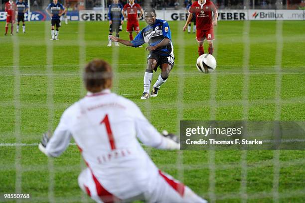 Chris Katongo of Bielefeld scores a penalty kick against goalkeeper Tobias Sippel of Kaiserslautern during the Second Bundesliga match between...