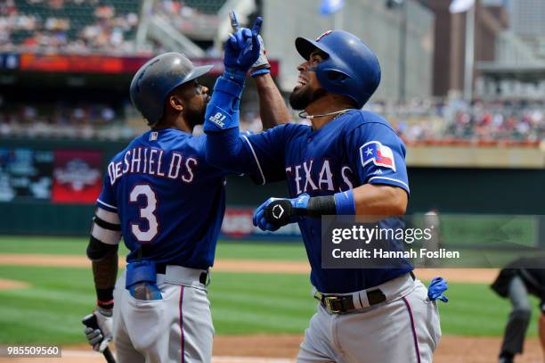 Delino DeShields of the Texas Rangers congratulates teammate Robinson Chirinos on a home run against the Minnesota Twins during the game on June 23,...