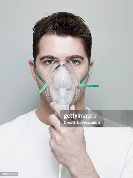 man wearing oxygen mask. - oxygen mask stock-fotos und bilder