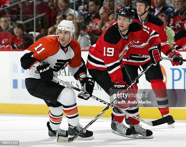 Blair Betts of the Philadelphia Flyers and Travis Zajac of the New Jersey Devils skate for position in Game Two of the Eastern Conference...