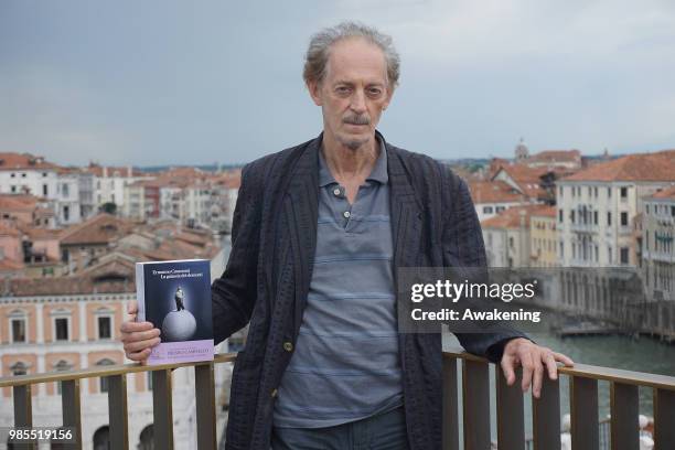 Italian writer Ermanno Cavazzoni shows the cover of his latest novel " La Galassia dei dementi" on June 27, 2018 in Venice, Italy. The five finalists...