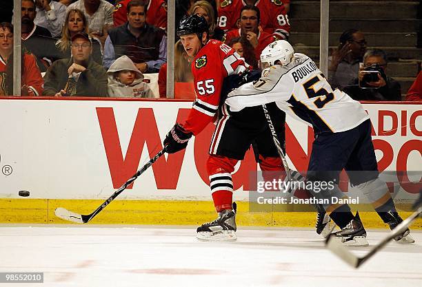 Francis Bouillon of the Nashville Predators pushes Ben Eager of the Chicago Blackhawks as he passes in Game One of the Western Conference...