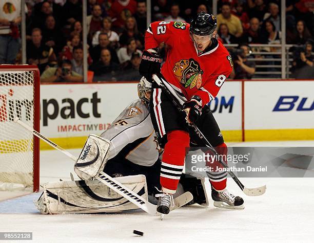 Tomas Kopecky of the Chicago Blackhawks passes the puck in front of Pekka Rinne of the Nashville Predators in Game One of the Western Conference...