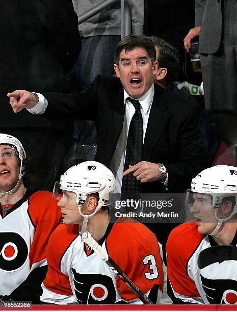 Head Coach Peter Laviolette of the Philadelphia Flyers gives instructions late in the third period against the New Jersey Devils in Game Two of the...