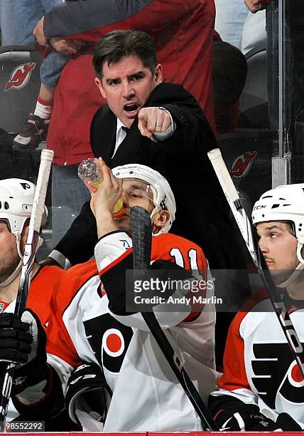 Head Coach Peter Laviolette of the Philadelphia Flyers gives instructions late in the third period against the New Jersey Devils in Game Two of the...