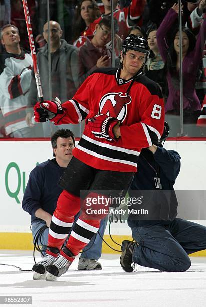 Dainius Zubrus of the New Jersey Devils salutes the fans after being named the first star of the game against the Philadelphia Flyers in Game Two of...