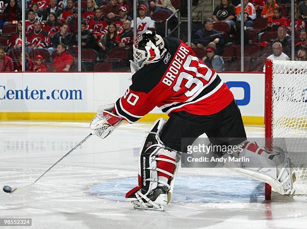 Martin Brodeur of the New Jersey Devils plays the puck against the Philadelphia Flyers in Game Two of the Eastern Conference Quarterfinals during the...