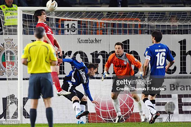 Srdjan Lakic scores his team's second goal against Zlatko Janjic, Dennis Eilhoff and Andre Mijatovic of Bielefeld during the Second Bundesliga match...