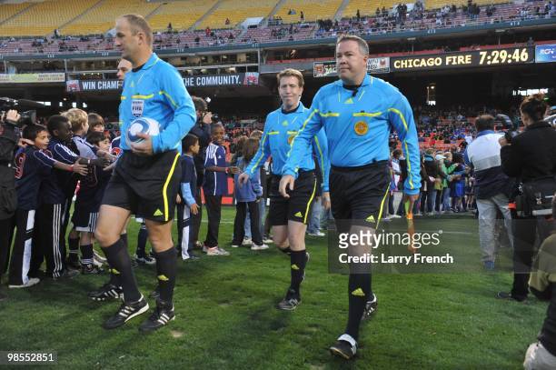 Referees Silviu Petrescu, Daniel Belleau and Steven Taylor take the field before the game between D.C. United and Chicago Fire at RFK Stadium on...