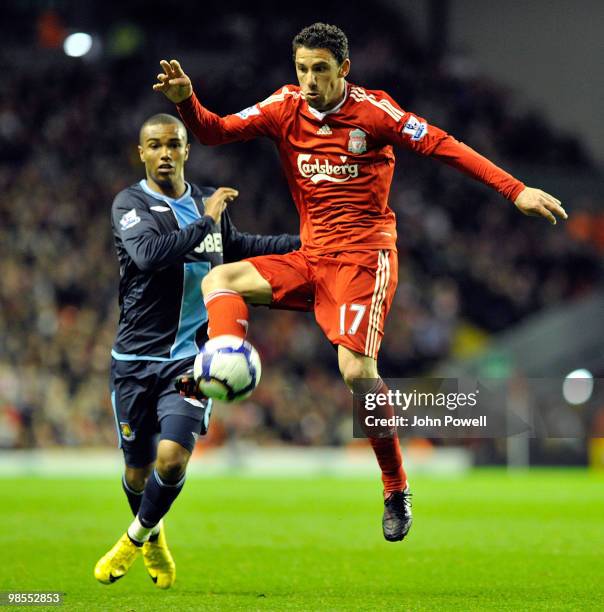 Maxi Rodriguez of Liverpool competes with Junior Stanisalas of West Ham during the Barclays Premier League match between Liverpool and West ham...