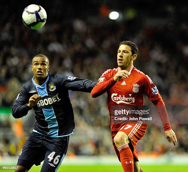 Maxi Rodriguez of Liverpool competes with Junior Stanisalas of West Ham during the Barclays Premier League match between Liverpool and West ham...