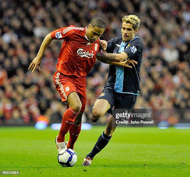 Glen Johnson of Liverpool competes with Valon Behrami of West Ham during the Barclays Premier League match between Liverpool and West ham United at...