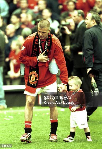 David Beckham of Man United with his son, Brooklyn as they celebrate winning the FA Carling Premiership trophy after the match between Manchester...