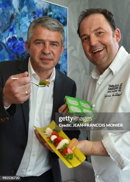 Olivier Clanchin, French President of the Triballat Noyal group poses with Sylvain Guillemot, chef of the "Auberge du Pont d'Acigne", during a taste...