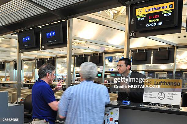 Passengers ask for information at a Lufthansa counter at the departure terminal of the Ataturk International airport in Istanbul on April 19, 2010....