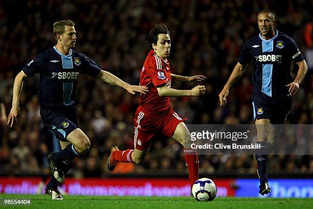 Yossi Benayoun of Liverpool surges away from Jonathan Spector of West Ham United during the Barclays Premier League match between Liverpool and West...