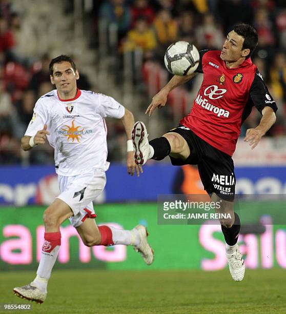Mallorca's forward Aritz Aduriz controls the ball next Osasuna's defender Josetxo Romero during their Spanish League football match at the Ono...