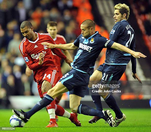 David Ngog of Liverpool competes with Matthew Upson of West Ham during the Barclays Premier League match between Liverpool and West ham United at...