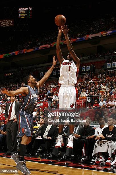 Dorell Wright of the Miami Heat shoots a jump shot against D.J. Augustin of the Charlotte Bobcats during the game at American Airlines Arena on March...