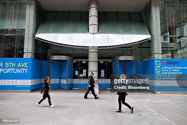 Pedestrians walk outside an empty retail store on the street level of 666 Fifth Avenue in New York, U.S., on Monday, April 19, 2010. New York's Fifth...