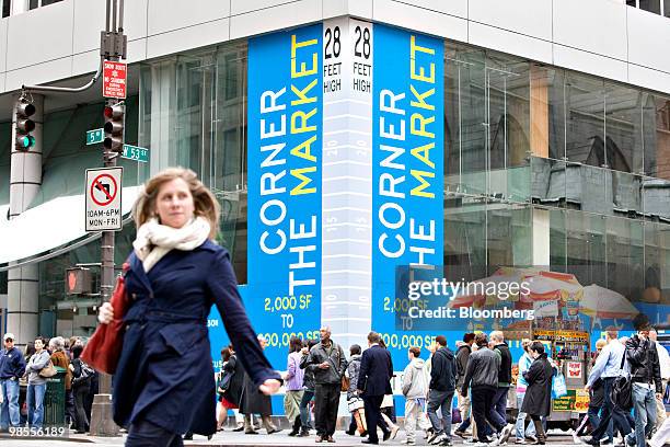 Pedestrians walk outside an empty retail store on the street level of 666 Fifth Avenue in New York, U.S., on Monday, April 19, 2010. New York's Fifth...