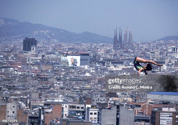 Summer Olympics: North Korea Kim Chun Ok in action during Women's 10M Platform at Piscina Municipal de Montjuic. View of Barcelona skyline in...
