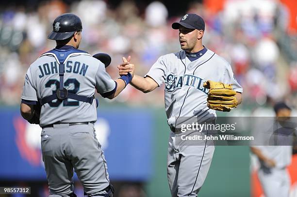 Pitcher David Aardsma and catcher Rob Johnson of the Seattle Mariners celebrate the final out of a win after the game against the Texas Rangers at...