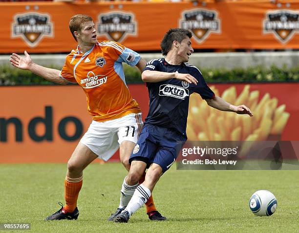 Andrew Hainult of the Houston Dynamo and Jorge Flores of Chivas USA fight for the ball at Robertson Stadium on April 17, 2010 in Houston, Texas.