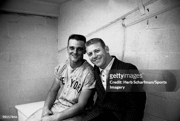 Roger Maris and Mickey Mantle of the New York Yankees relax in the clubhouse after a MLB game against the Baltimore Orioles on September 20, 1961 in...