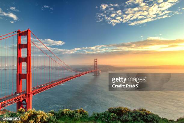the golden gate bridge during sunset in san francisco, california. - san francisco california stock-fotos und bilder