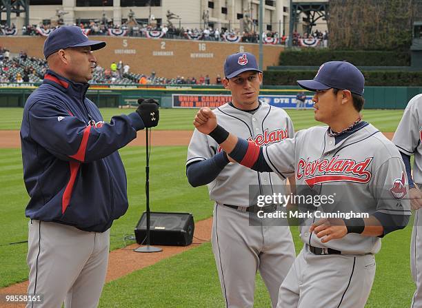 Manager Manny Acta and Shin-Soo Choo of the Cleveland Indians bump fists during player introductions before the Opening Day game against the Detroit...