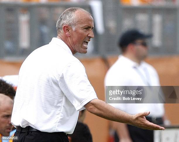 Head coach Dominic Kinear of the Houston Dynamo yells out instructions to his players at Robertson Stadium on April 17, 2010 in Houston, Texas.