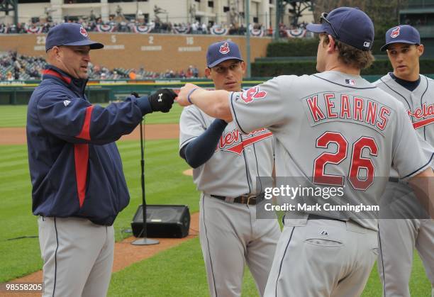 Manager Manny Acta and Austin Kearns of the Cleveland Indians bump fists during player introductions before the Opening Day game against the Detroit...
