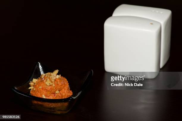 dish of orange paste beside white cruet - cruet stock pictures, royalty-free photos & images