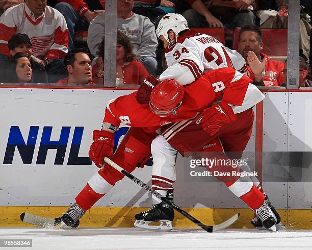 Justin Abdelkader of the Detroit Red Wings battles along the boards with Daniel Winnik of the Phoenix Coyotes during Game Three of the Eastern...