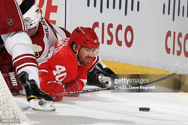 Henrik Zetterberg of the Detroit Red Wings reaches for the puck while laying on the ice during Game Three of the Eastern Conference Quarterfinals of...