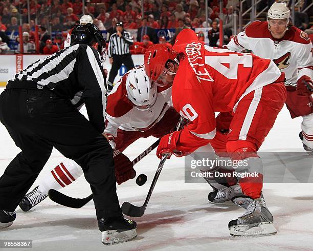 Henrik Zetterberg of the Detroit Red Wings battles for the puck on a face-off with Petr Prucha of the Phoenix Coyotes during Game Three of the...