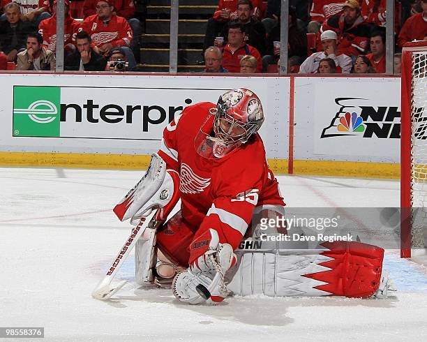 Jimmy Howard of the Detroit Red Wings makes a glove save during Game Three of the Eastern Conference Quarterfinals of the 2010 NHL Stanley Cup...