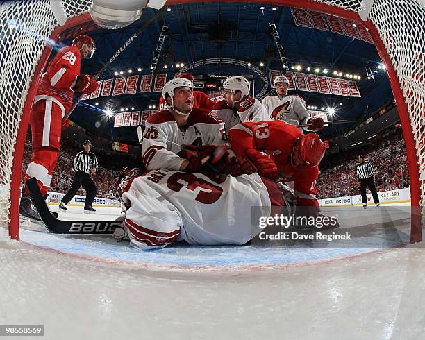 Ilya Bryzgalov of the Phoenix Coyotes covers the puck as teammate Ed Jovanovski battles with Pavel Datsyuk of the Detroit Red Wings during Game Three...