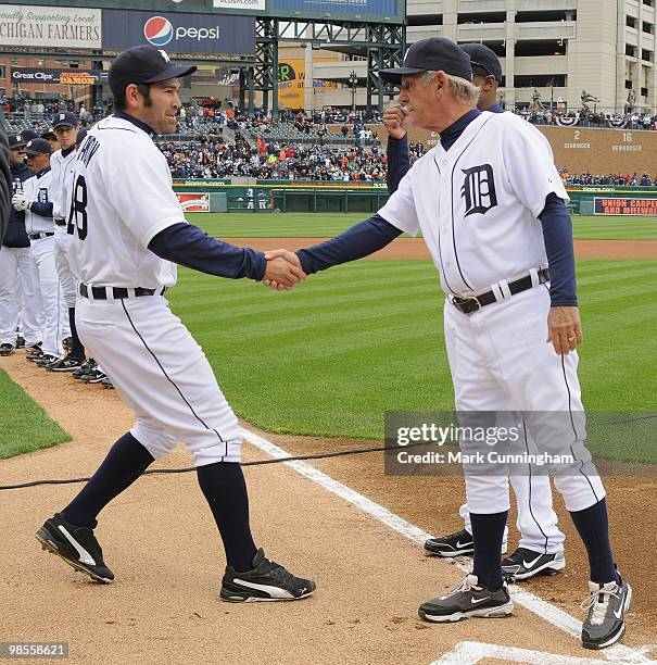 Johnny Damon and manager Jim Leyland of the Detroit Tigers shake hands during player introductions before the Opening Day game against the Celveland...