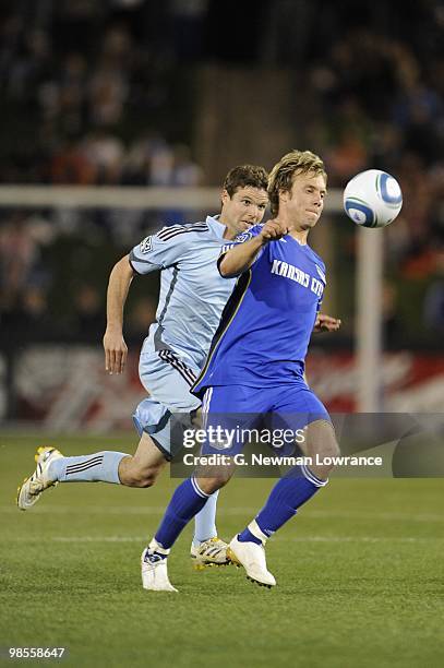 Michael Harrington of the Kansas City Wizards plays the ball under pressure from Drew Moor of the Colorado Rapids during their MLS match on April 10,...