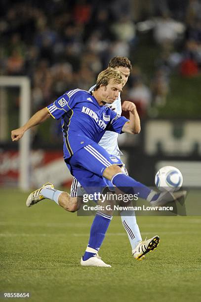 Michael Harrington of the Kansas City Wizards plays the ball under pressure from Drew Moor of the Colorado Rapids during their MLS match on April 10,...