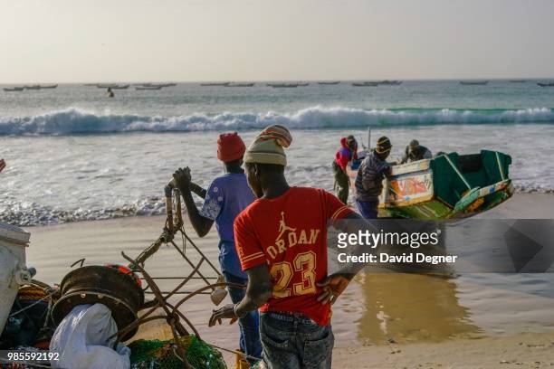 Fisherman return with the days catch at sunset on the beach of Nouakchott, Mauritania. Most of the fishermen are from Senegal but fish in the waters...