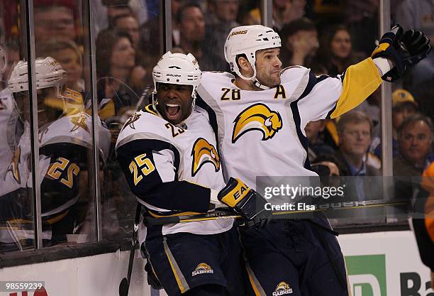 Michael Grier of the Buffalo Sabres celebrates with teammate Paul Gaustad after Grier scored a goal in the first period against the Boston Bruins in...