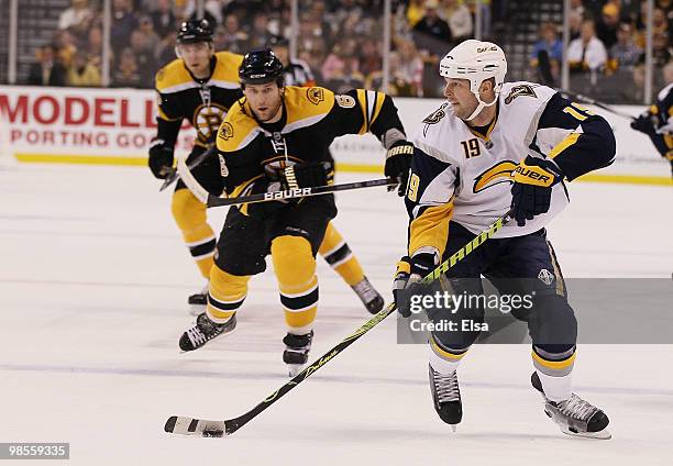 Tim Connolly of the Buffalo Sabres heads for the net as Dennis Wideman of the Boston Bruins defends in Game Three of the Eastern Conference...