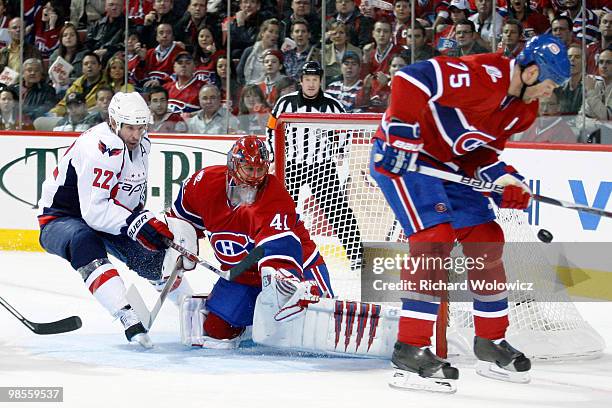 Jaroslav Halak of the Montreal Canadiens stops the puck while being rushed by Mike Knuble of the Washington Capitals in Game Three of the Eastern...