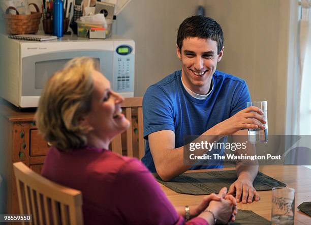 Debbie Anzelone, L, with adopted son Jeff in the background share laughs during dinner at their home on March 24 in Beltsville, MD. Debbie Anzelone...