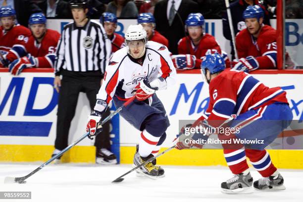 Alex Ovechkin of the Washington Capitals stick handles the puck while being defended by Jaroslav Spacek of the Montreal Canadiens in Game Three of...