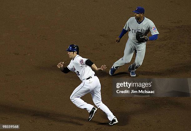 Ike Davis of the New York Mets leads off first base against Derek Lee of the Chicago Cubs during the second inning on April 19, 2010 at Citi Field in...